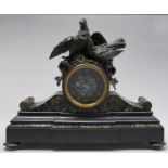 A French bronze mounted verde antico and belge noir mantel clock, the drum cased movement surmounted