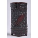 A Japanese carved, stained and inlaid bamboo brush pot, Meiji period, with sea creatures and