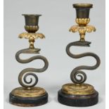 A pair of George IV parcel gilt bronze serpent candlesticks, c1830, one with nozzle, 19cm h