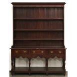 An oak dresser, early-mid 19th c, the rack with flared cornice above a frieze set eight wrought iron