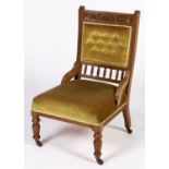 A Victorian walnut nursing chair, c1880, with moulded frame, the top rail foliate carved on a matted
