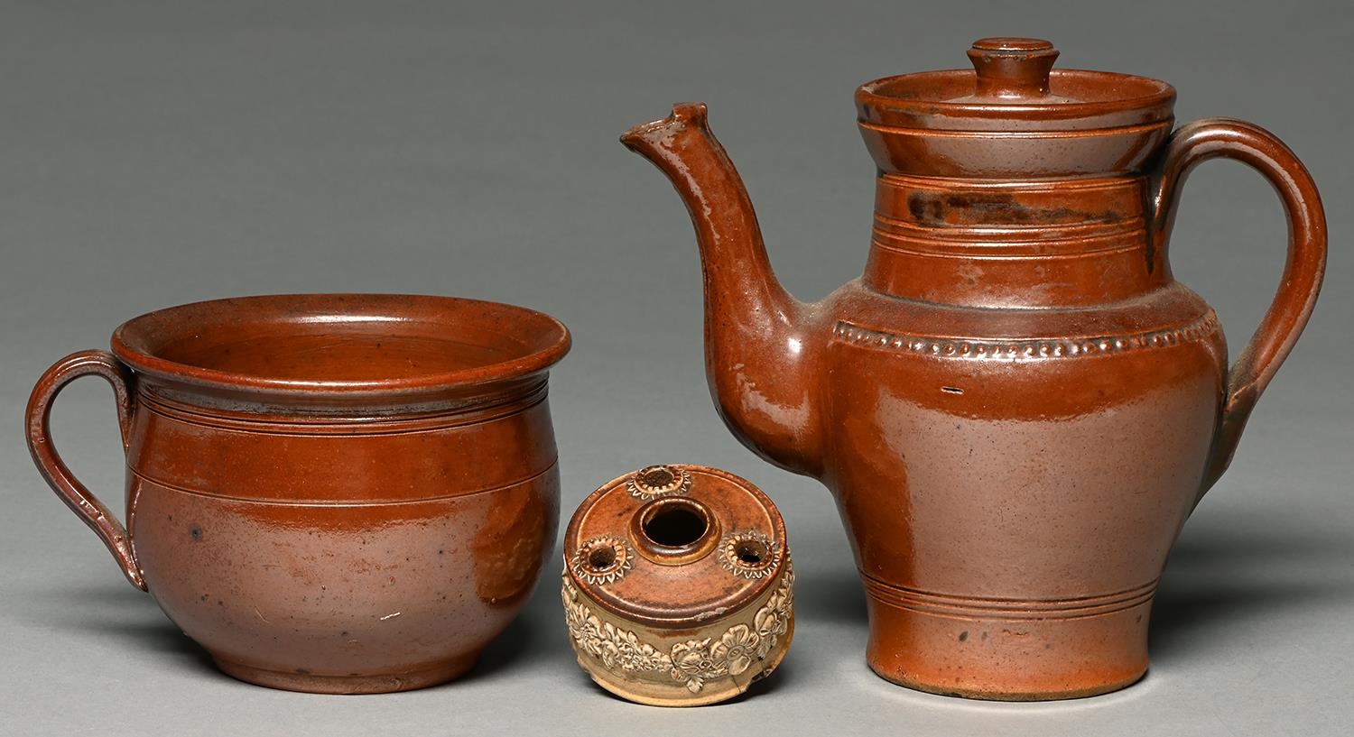 A Derbyshire saltglazed brown stoneware handled pot or porringer, Chesterfield or Brampton, late