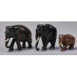 Two carved ebony sculptures of elephants, late 19th / early 20th c, with ivory tusks, 20 and 22cm