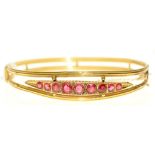 A synthetic ruby bangle, in gold, 63mm, unmarked, 6.1g Slight distortion on lower half