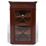An Edwardian mahogany hanging corner cabinet, c1910, with dentil moulded cornice and blind fret