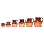 Six graduated Doulton saltglazed brown stoneware hunting jugs, late 19th c, largest 18cm h,