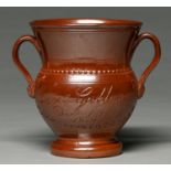 A Derbyshire saltglazed brown stoneware loving cup, Chesterfield or Brampton, dated 1829, of typical