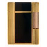 An S T Dupon gold plated and black lacquer cigarette lighter, No C7DAO7, maker's box and booklet
