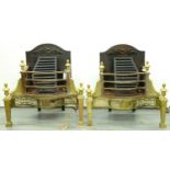 A pair of brass and burnished steel serpentine basket grates, 20th c, in neo classical style, urn