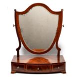 A Victorian mahogany dressing mirror, with shield shaped plate, the bow fronted, figured base fitted