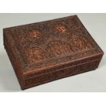 An Indian sandalwood box, c1880, the lid and sides intricately carved with deities and densely