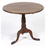 A George IV oak tripod table, 70cm h; 85cm diam Old repair to top, lock original, legs not spliced