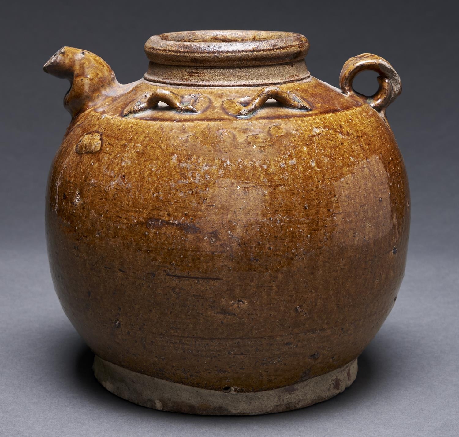 A South East Asian globular stoneware ewer, with four bow shaped shoulder handles, the rich brown