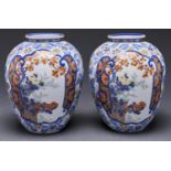 A pair of Japanese Koransha vases, shouldered oviform and decorated with two panels of