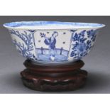 A Chinese blue and white bowl, with flanged rim, painted on the exterior with panels of figures