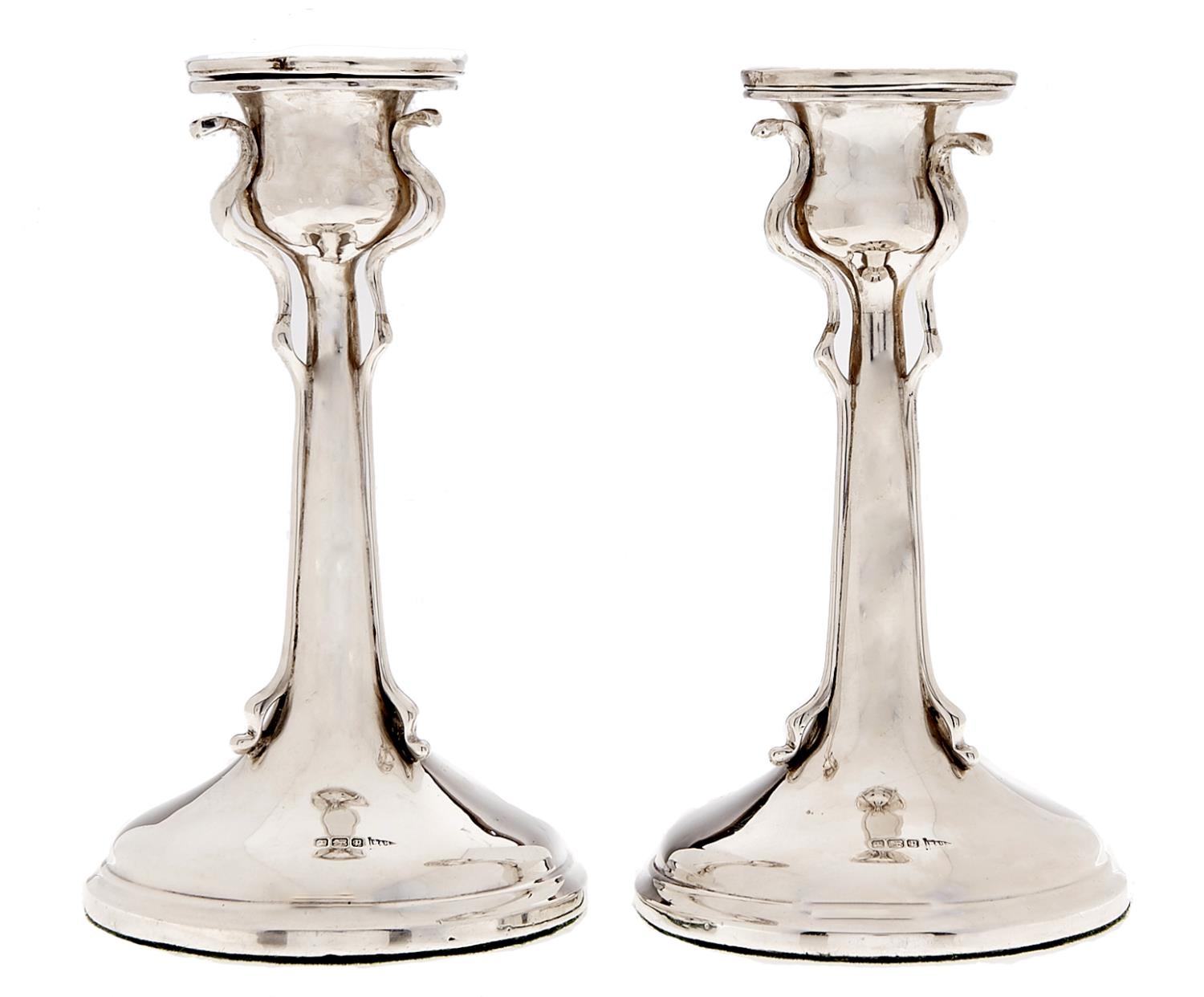 A pair of Edwardian art nouveau silver candlesticks, nozzles, 16cm h, by Walker & Hall, Sheffield