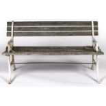 A garden seat with cast metal scrolling ends, wood slats, seat height 38cm h, 122cm l Weathered,