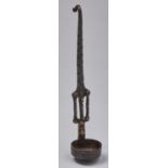 An Indian brass and iron ladle, 19th c, the bowl on decorated stem with spiral ornament and hook