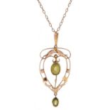 An art nouveau peridot pendant, in gold, of openwork design with drop, on a later 9ct gold