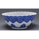 A Chinese blue and white bowl, with rounded sides and everted, scalloped rim, painted with deep