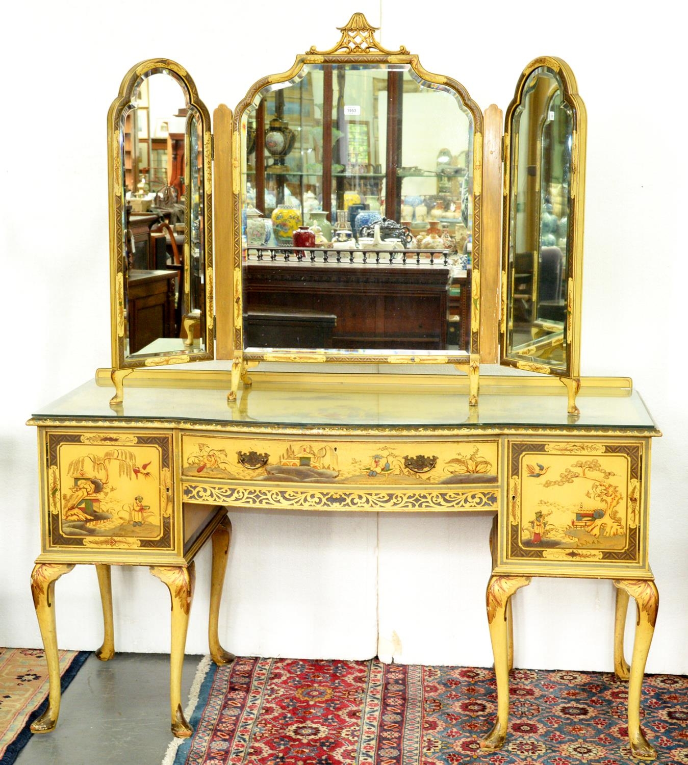 A jappaned dressing table, c1930's, the top with bow centre, decorated with figures and fishermen in