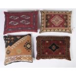 Four various Persian design woolwork covered cushions, 55cm l and smaller Good condition