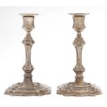 A pair of George V silver candlesticks, in George II style, nozzles, 18.5cm h, loaded, marks rubbed,