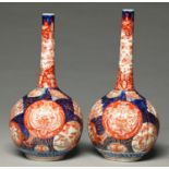 Two Japanese Imari drumstick vases with matching decoration, Meiji period, 30 and 31cm h Wear to