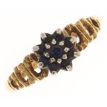 A sapphire cluster ring, in gold with pierced shoulders, 2.4g, size P