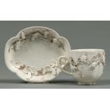 A Chinese blanc de chine coffee cup and saucer, 18th c, with applied decoration,  saucer 12.5cm l,