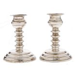 A pair of Victorian silver dwarf candlesticks, with spool knopped stem, on round tiered foot, 11cm