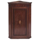 A Victorian splay fronted mahogany hanging corner cupboard, panelled door with shell patera, 104cm
