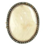 A paste, semi opalescent paste and gold cameo brooch of the head of the Madonna, early 20th c,