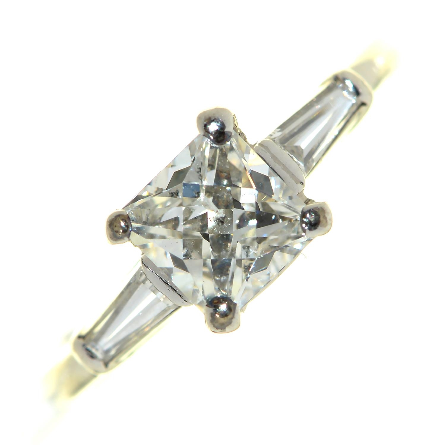 An Art Deco diamond ring, the French cut larger central diamond of approx 1ct flanked by trapeze cut