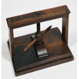 A George III mahogany book press, with helix and two handles, moulded rectangular base, 36cm l Old