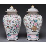 A pair of Chinese famille rose vases and covers, decorated with finches and flowers, 24cm h Good