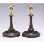 A pair of brass mounted and turned mahogany candlesticks, 19th c,  nozzles, 23cm h Good quality