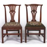 A pair of George III elm dining chairs, c1790, serpentine top rails above pierced waisted scroll