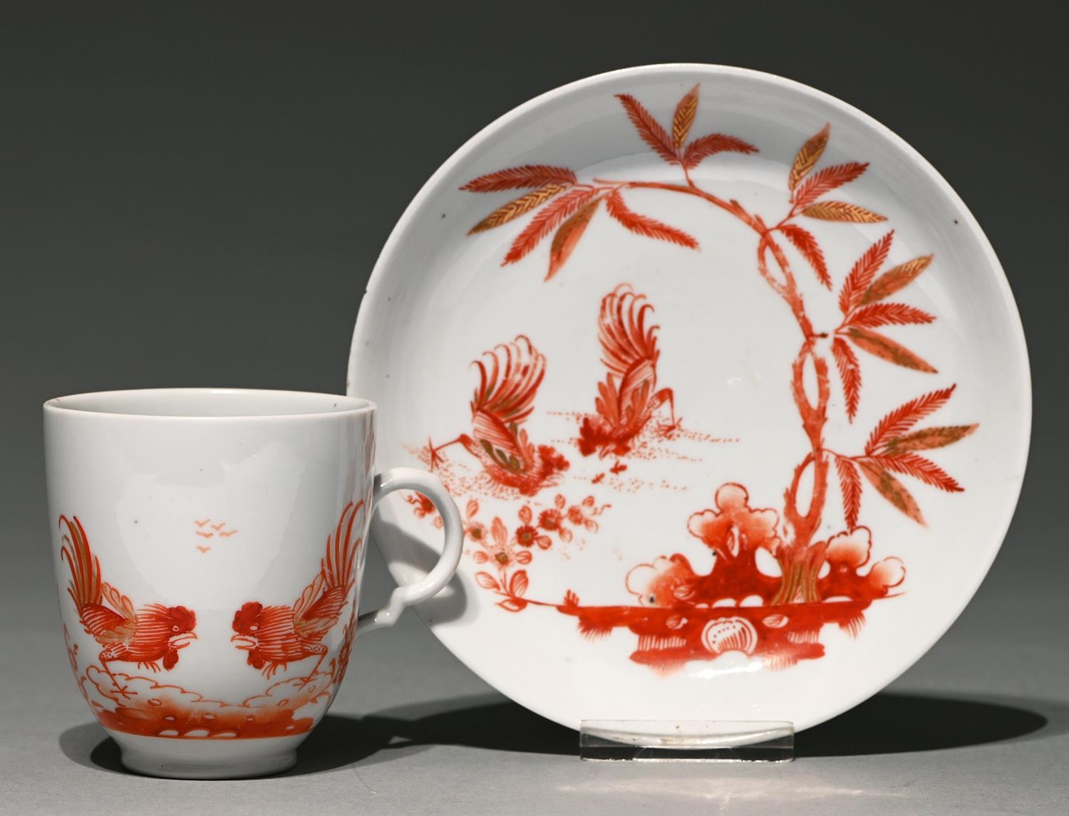 A Doccia coffee cup and saucer, late 18th c, painted in iron red enamel and gilt with two fighting