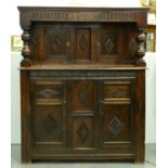 An oak court cupboard in early 17th c style, Victorian and later, the shallow cornice above a