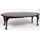 A mahogany extending dining table in Queen Anne style, the oval top with two additional leaves,