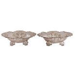 A pair of Victorian die stamped and pierced silver sweetmeat dishes, on four  floral feet, 18.5cm l,