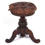 A Victorian rosewood piano stool, c1870, with leaf carved knop and buttoned leather covered