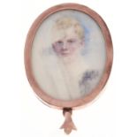 A double sided oval gold locket, set with a contemporary early 20th c portrait miniature of a boy,