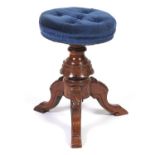 A Victorian walnut piano stool, with scalloped pillar and three legs carved with leaves, 49cm h