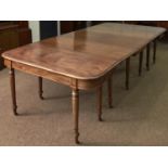 A William IV mahogany dining table, the figured top with ovolo lip and rounded corners