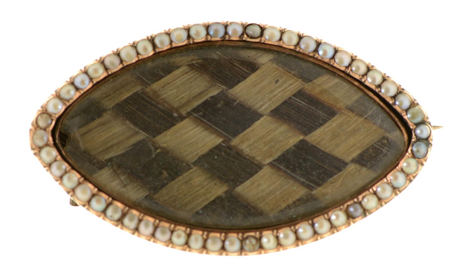 A Georgian shuttle shaped split pearl and gold mourning brooch, early 19th c, inset plaited hair,