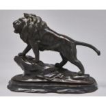 A Japanese bronze sculpture of a lion, Genryusai Seiya Studio, Meiji period, reddish brown patina,