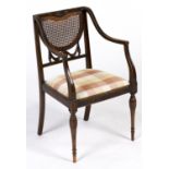 A mahogany elbow chair, in neo classical style, early 20th c, the carved back with caned splat on