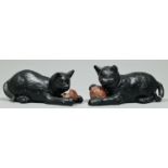 A pair of Bretby black painted pottery kittens, c1900, one playing with a ball of wool, the other